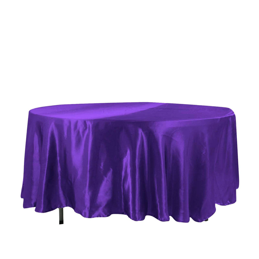 Purple round table cover with elegant drape.