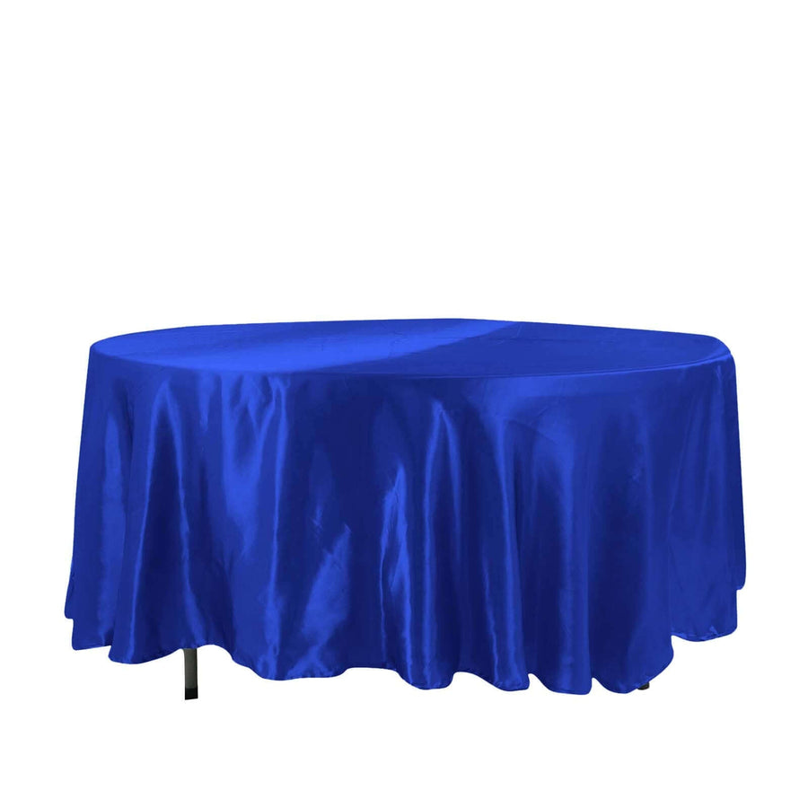 Blue satin tablecloth draped over an oval table on a white background