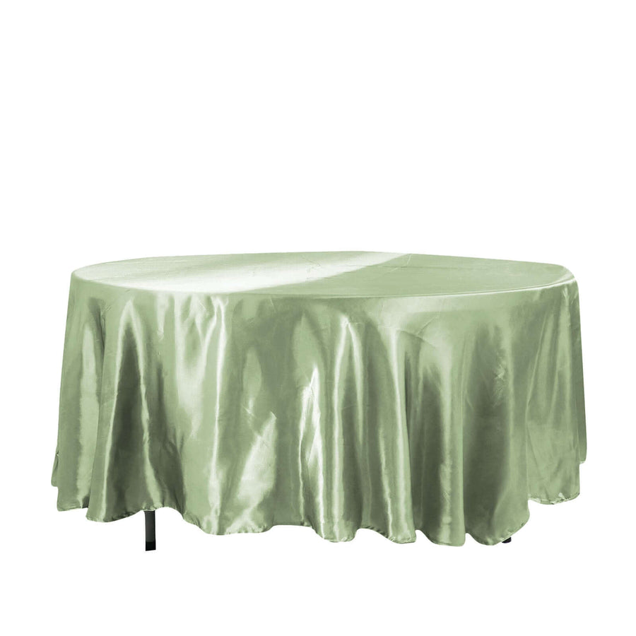 Green satin tablecloth draped elegantly over a round table
