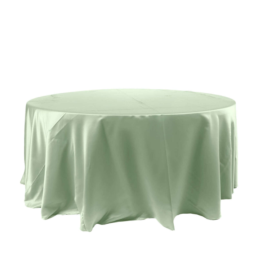Round mint green tablecloth on a white backdrop.