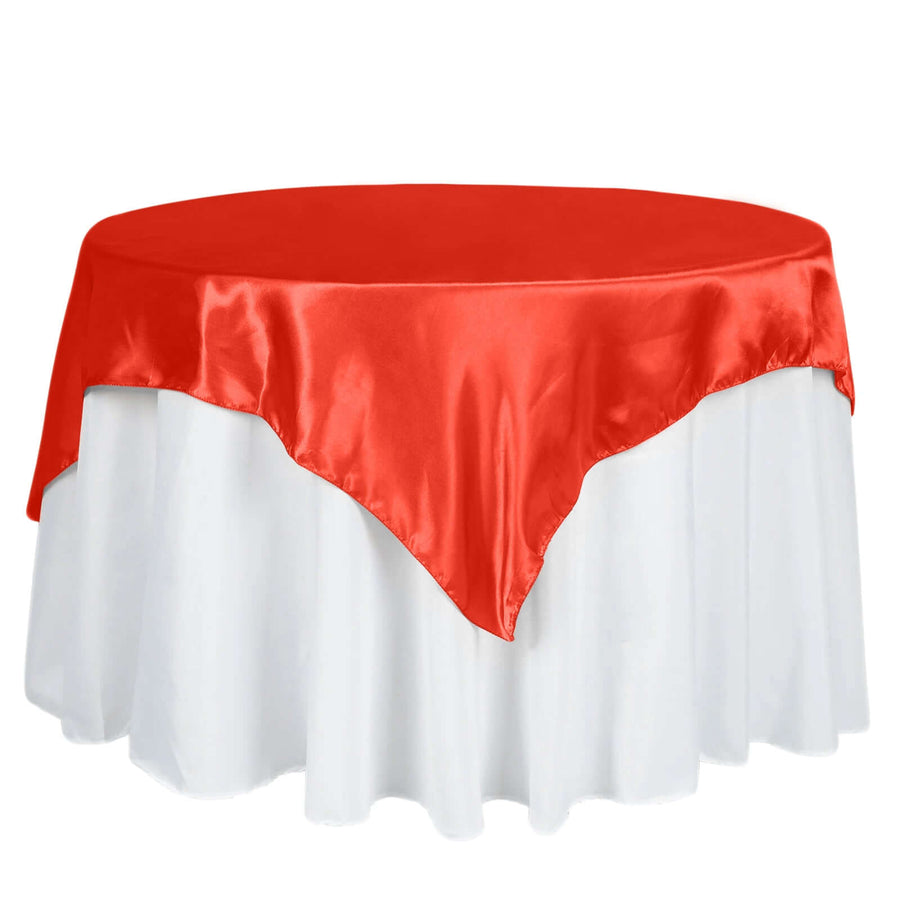 Red satin table cover on a round white table