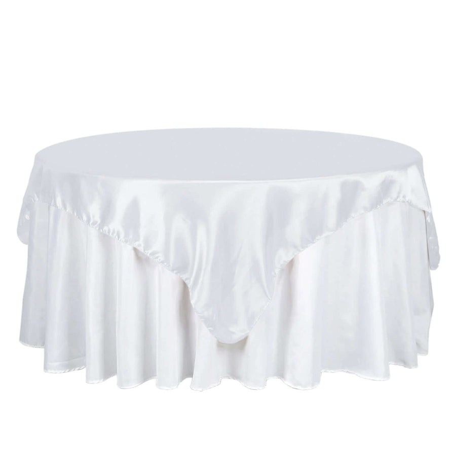 White satin tablecloth draped elegantly over a round table