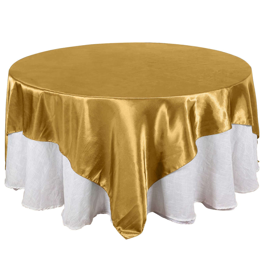 Gold round tablecloth with white ruffled hem, perfect for elegant events.