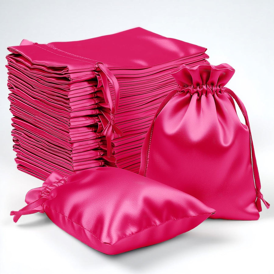 Stack of pink satin bags in various sizes on a white background.