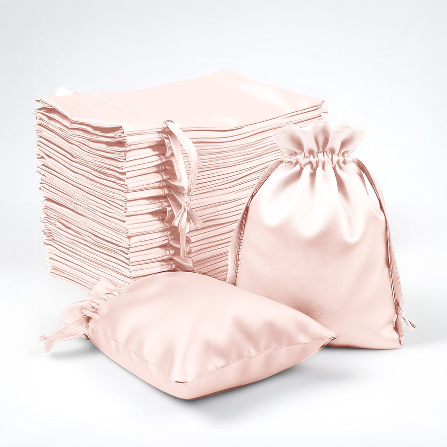 Stack of pink fabric bags on a white background.