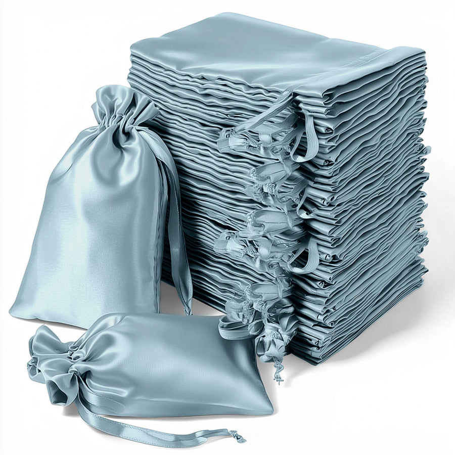 Stack of elegant blue satin bags on a white background
