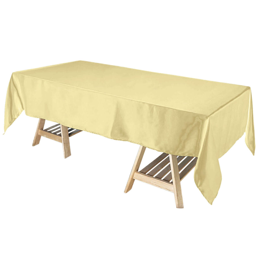 Yellow tablecloth draped over a wooden table.
