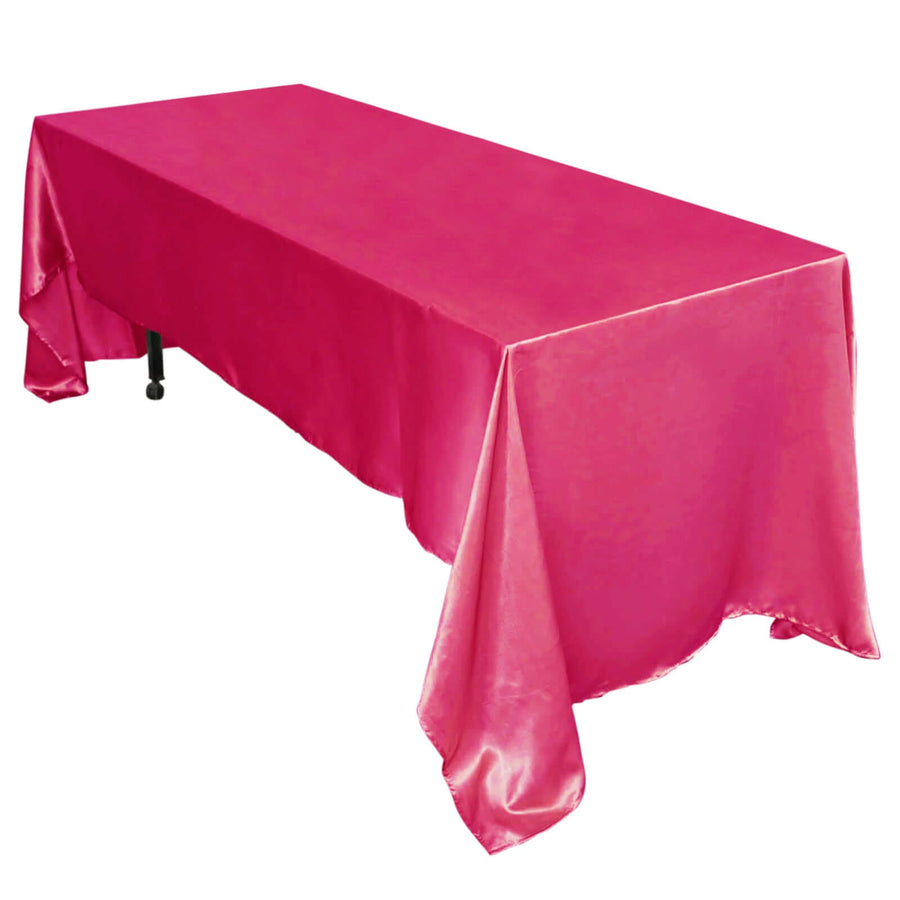 Pink satin tablecloth draped over a rectangular table