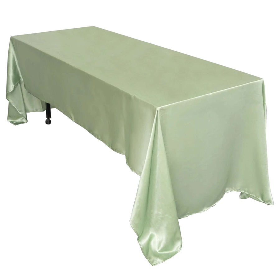Green satin tablecloth draped over a rectangular table