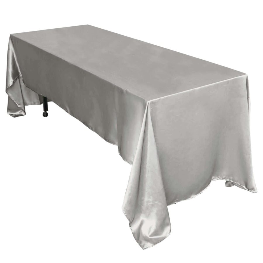 Silver satin tablecloth draped elegantly over a rectangular table