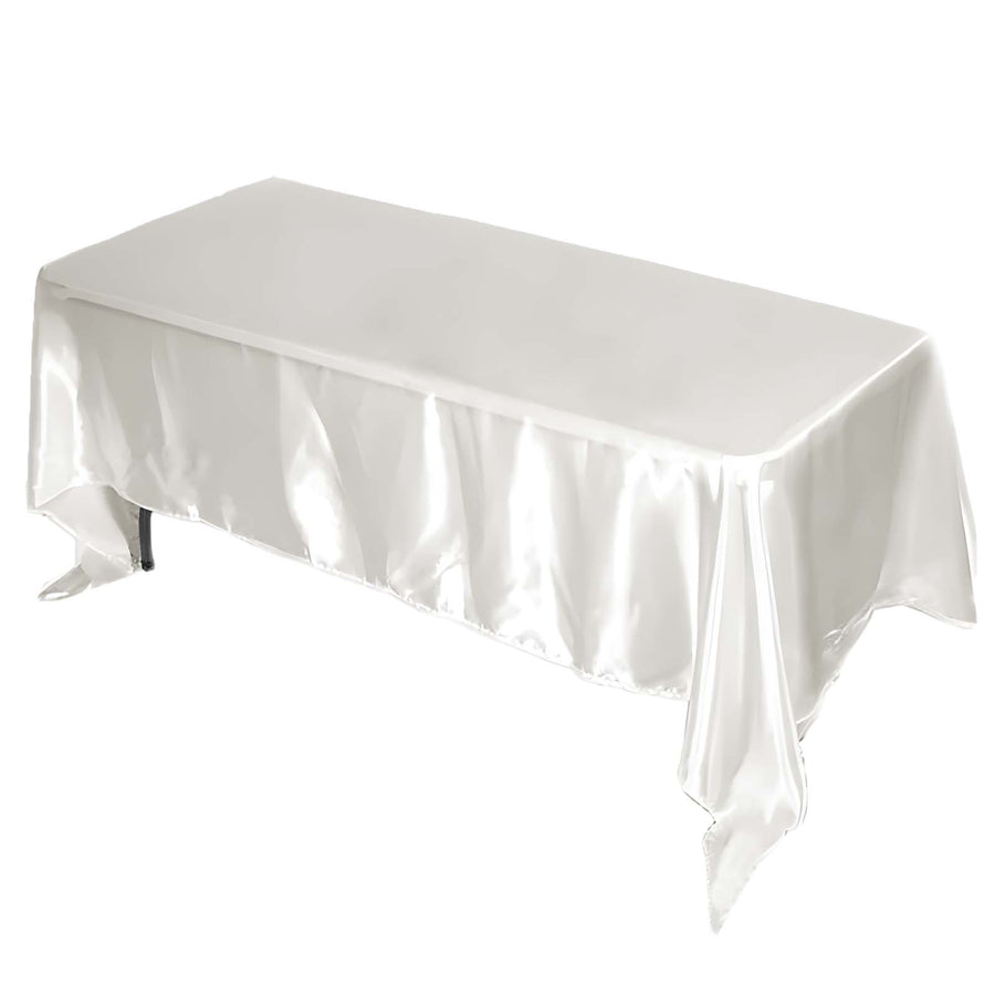 White satin tablecloth draped over a rectangular table