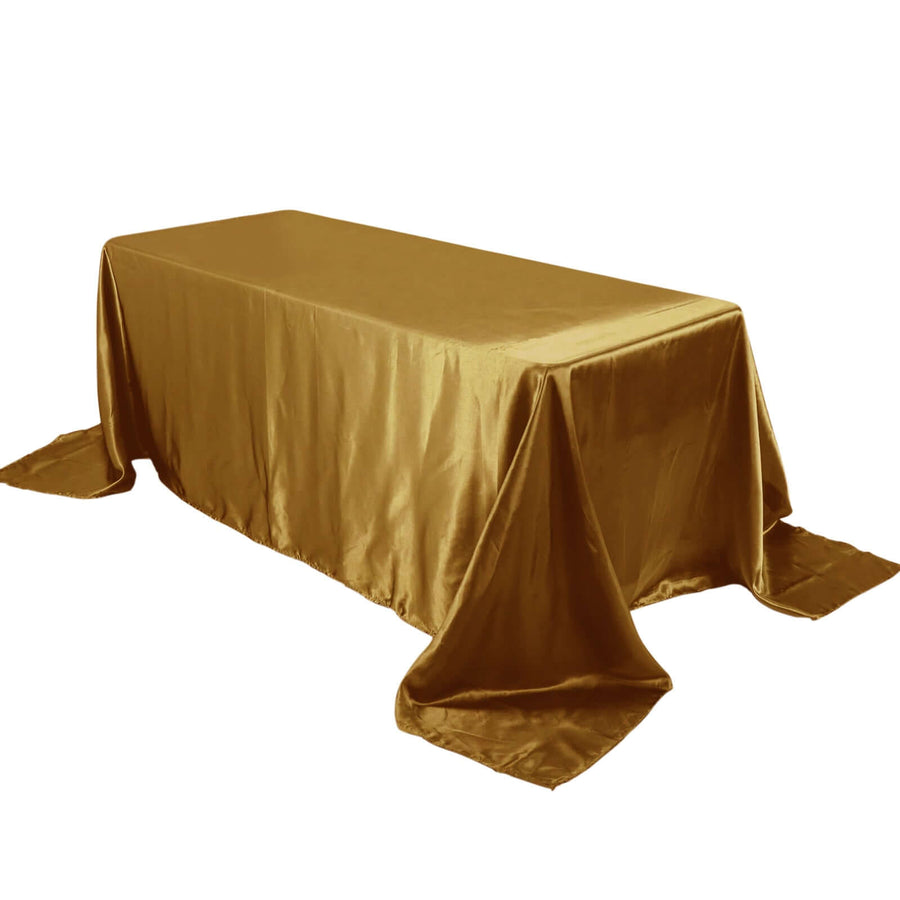 Gold satin tablecloth draping a rectangular table