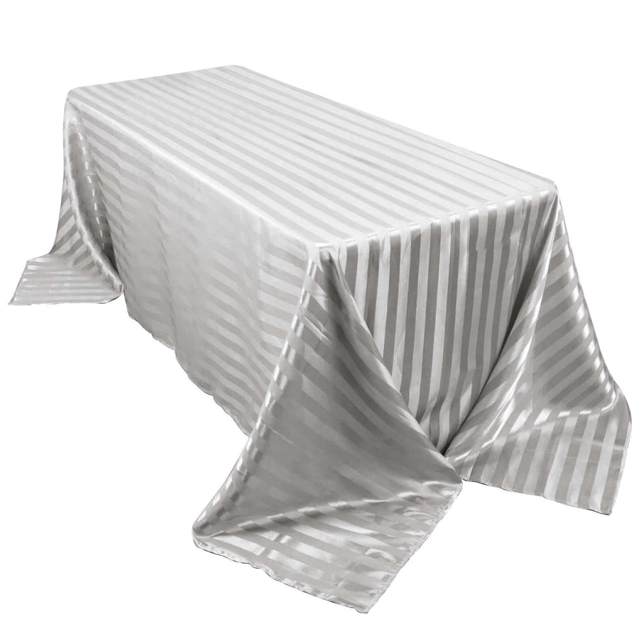 Silver striped tablecloth draped over a table, highlighting its elegant texture.