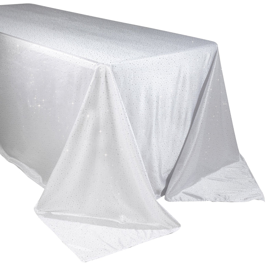 Sparkling white tablecloth with shimmering detail on a plain background