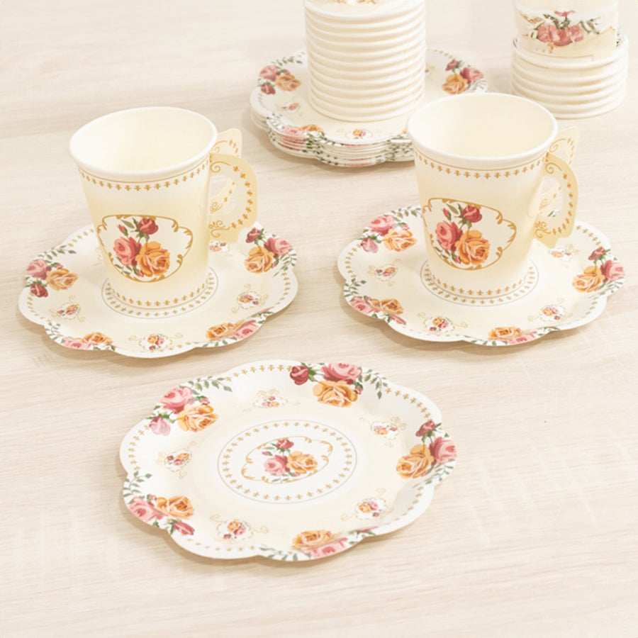 Floral tea set with cups and saucers on a light background.
