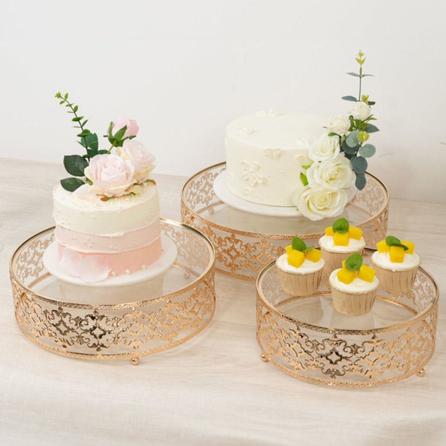 Elegant dessert display with cakes and cupcakes on decorative stands.