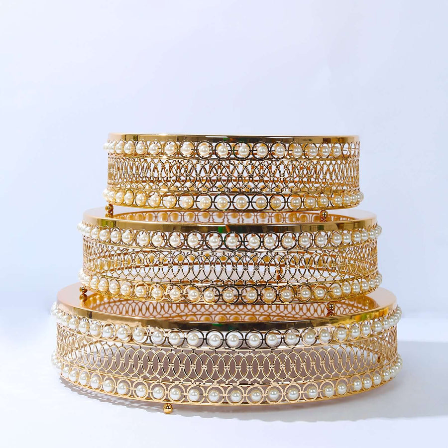 Gold and pearl decorative trays stacked on a white background