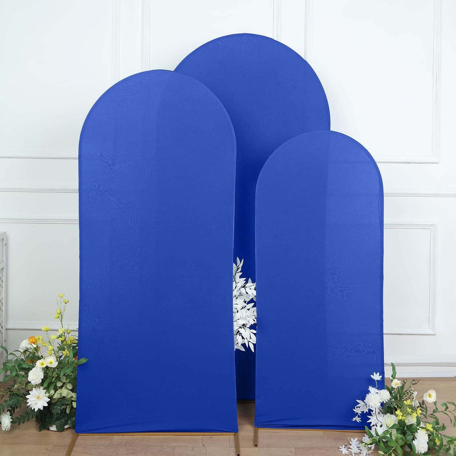 Blue fabric backdrops in three sizes with floral accents on the floor.