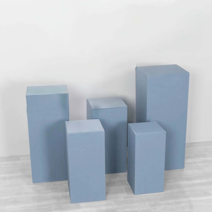 Blue display pedestals in various heights arranged on a light background.