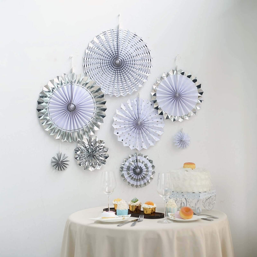 Silver and white paper fan decorations for a festive celebration.