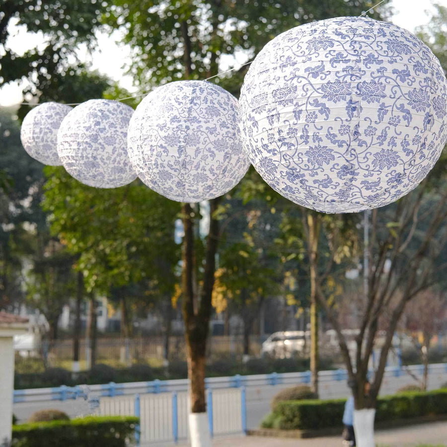 Decorative blue and white paper lanterns hanging outdoors.
