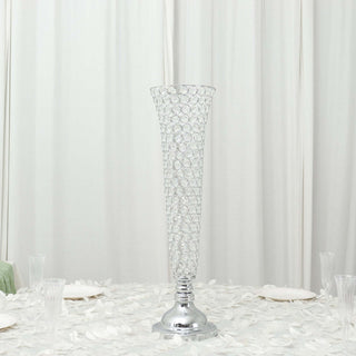 Elegant crystal vase on a table with white floral decor.