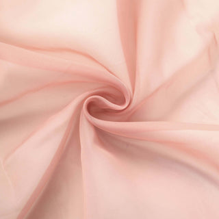 Light pink sheer fabric with a soft, flowing texture. #whtbkgd