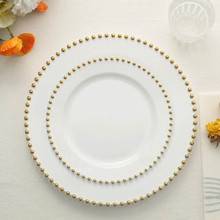 White plates with gold beaded edges arranged in a stack.