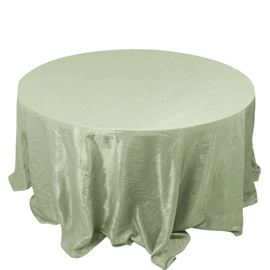 Round green tablecloth with elegant texture and draping.