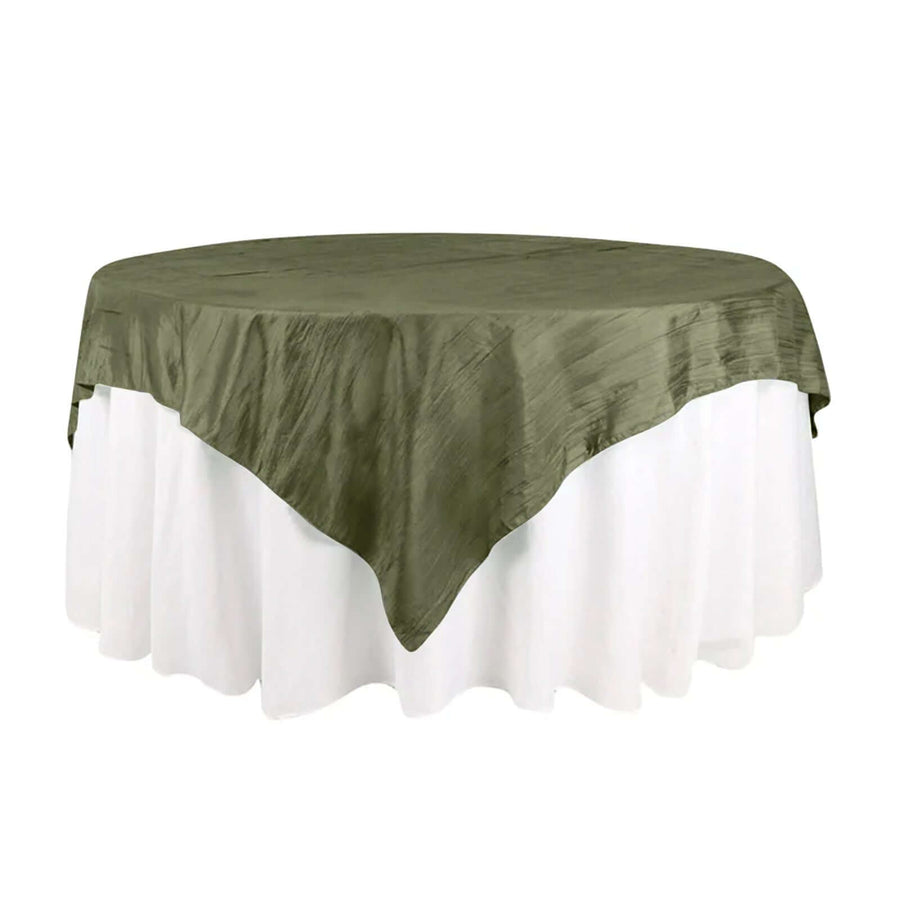Olive green tablecloth on a round table with white skirt