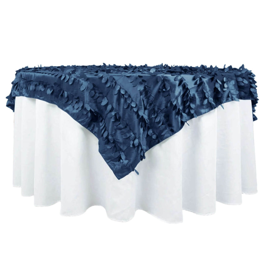 Navy blue leaf-pattern tablecloth draped over a white table