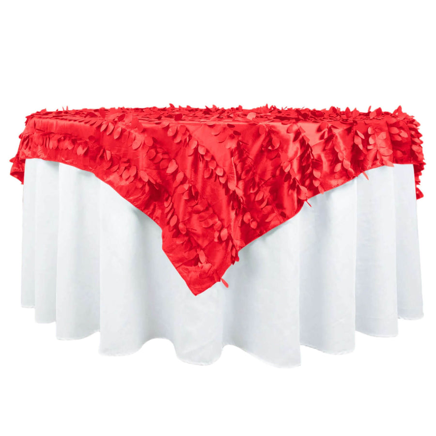Red table cover with textured petal design on a white tablecloth.