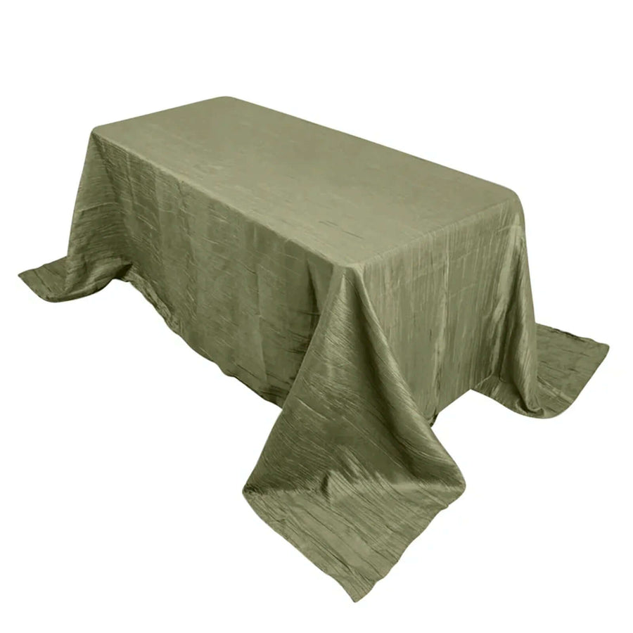 Olive green textured tablecloth draped over a rectangular table