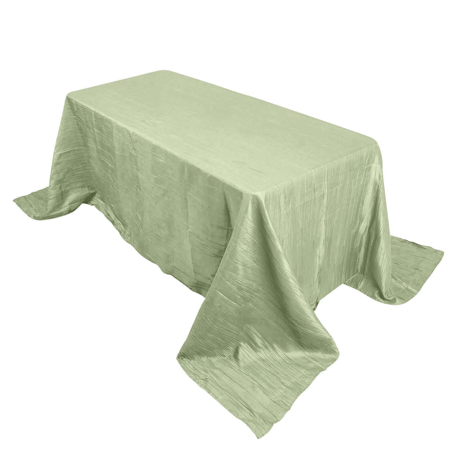 Light green tablecloth draped over a rectangular table