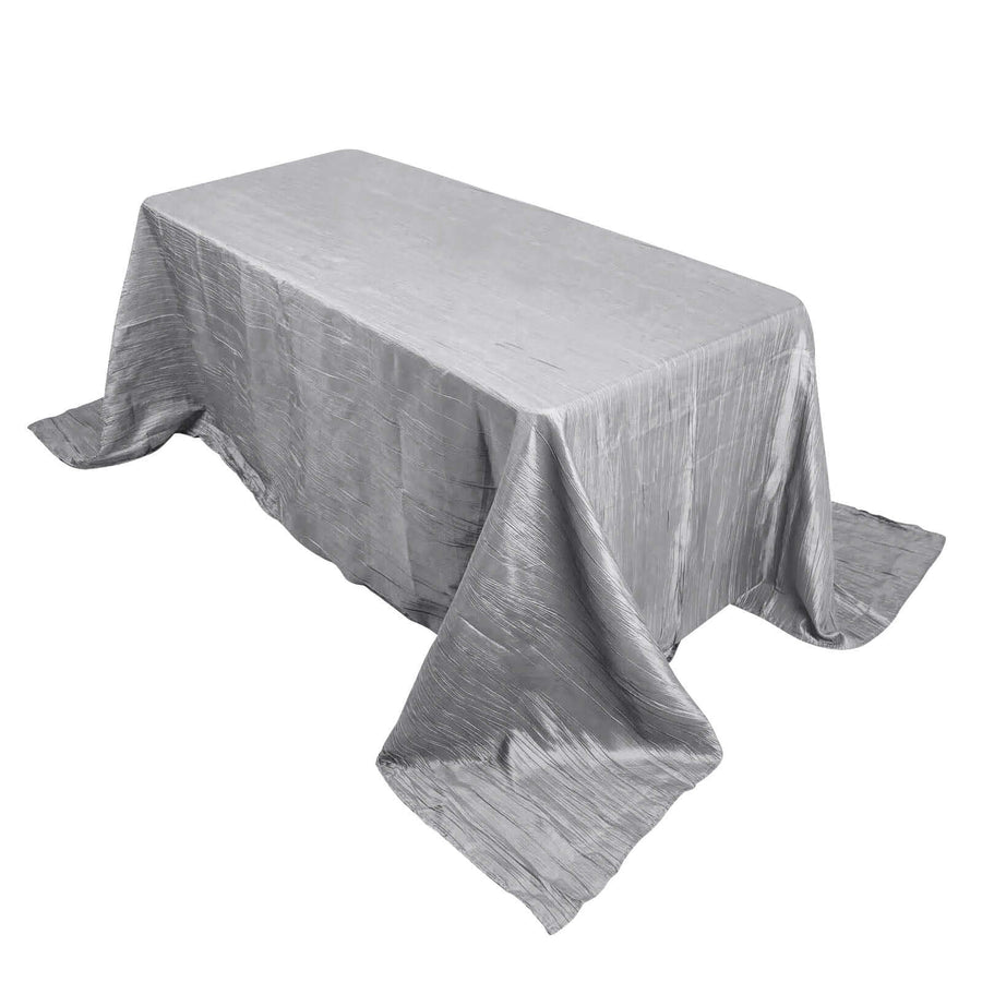 Silver tablecloth draped elegantly over a rectangular table.