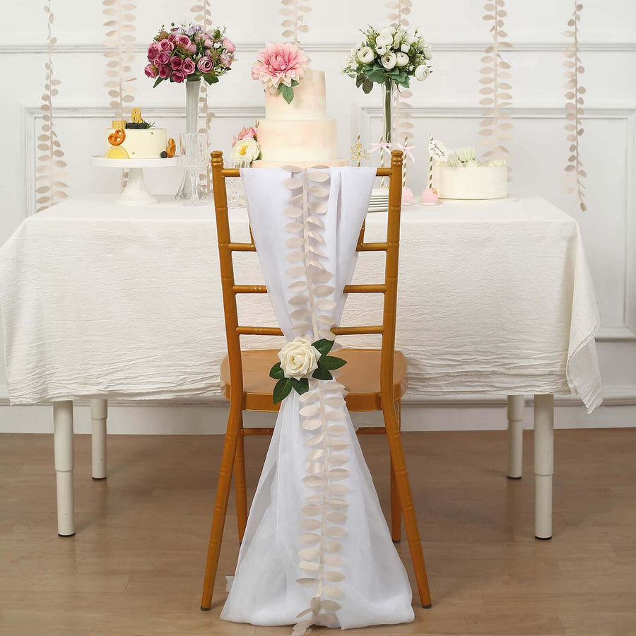 Decorative chair with white fabric and rose, set for a festive table.