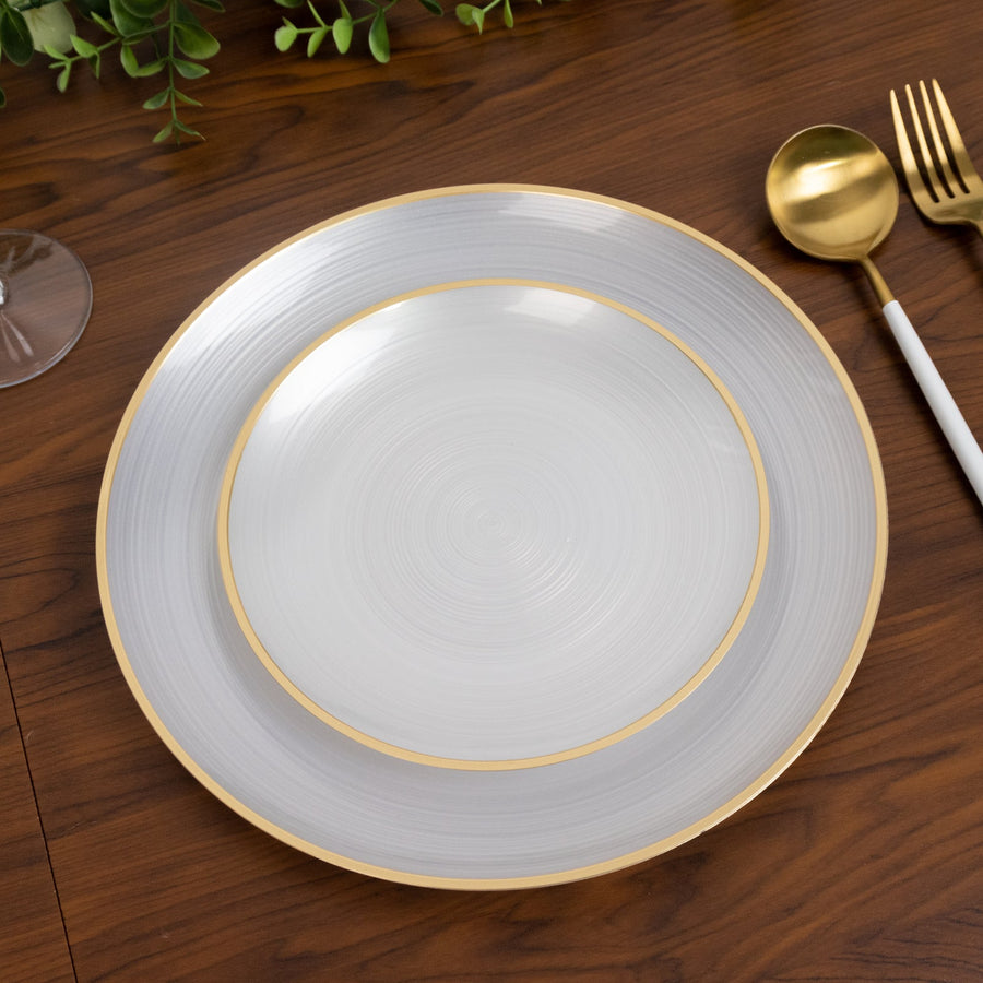 Elegant gray and gold dinner plate set on a wooden table.
