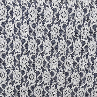 Lace fabric with floral pattern in white on a dark background.