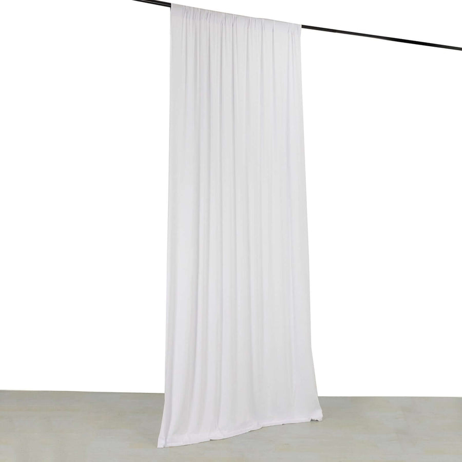 White fabric curtain hanging from a rod against a plain background