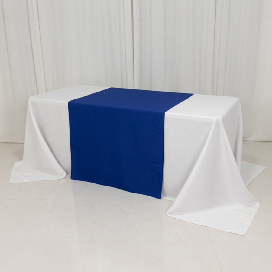 White table with a blue table runner in a studio setting