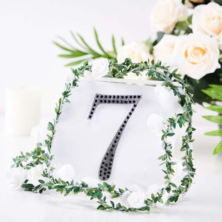Elegant table number 7 with floral accents and greenery.