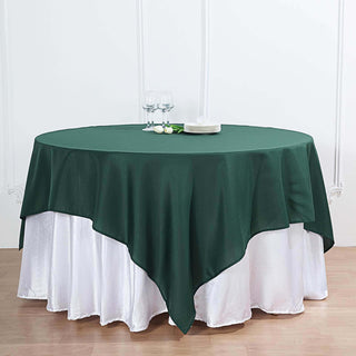 Add Elegance to Your Event with the 70"x70" Hunter Emerald Green Square Polyester Table Overlay Add Elegance to Your Event with the 70"x70" Hunter Emerald Green Square Polyester Table Overlay