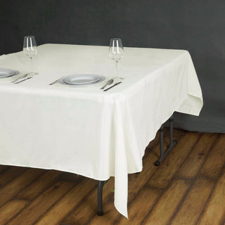 Elevate Your Events with the 70"x70" Ivory Square Seamless Polyester Tablecloth