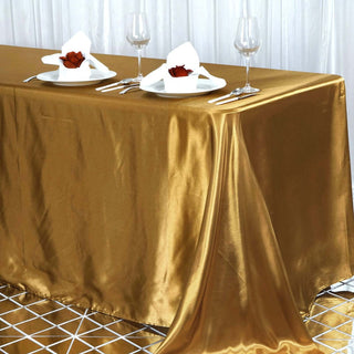 Add a Touch of Elegance with the 90"x156" Gold Seamless Satin Rectangular Tablecloth Add a Touch of Elegance with the 90"x156" Gold Seamless Satin Rectangular Tablecloth