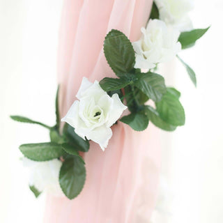 White roses on a pink fabric backdrop