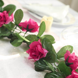 Artificial pink rose garland on a table setting.