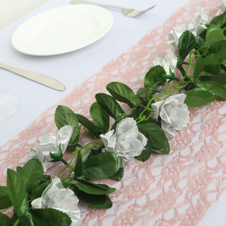Artificial white rose garland on lace table runner