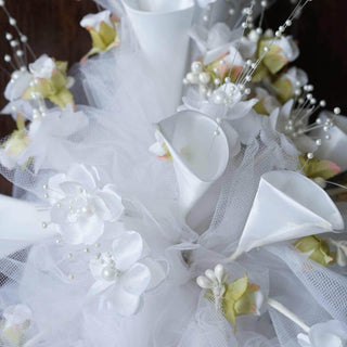 White floral wedding bouquet with delicate accents and tulle.