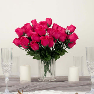 Bouquet of pink roses in a clear vase on a table setting.