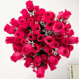 Bright pink artificial rose bouquet with white filler flowers.